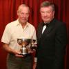 Ralph , as the previous holder, presents the Dargan Trophy to Cyril Vincent