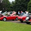 CLUB MEMBERS JUDGING THE CARS - SEEN FROM BEHIND THE STANDARD CAR LINE UP